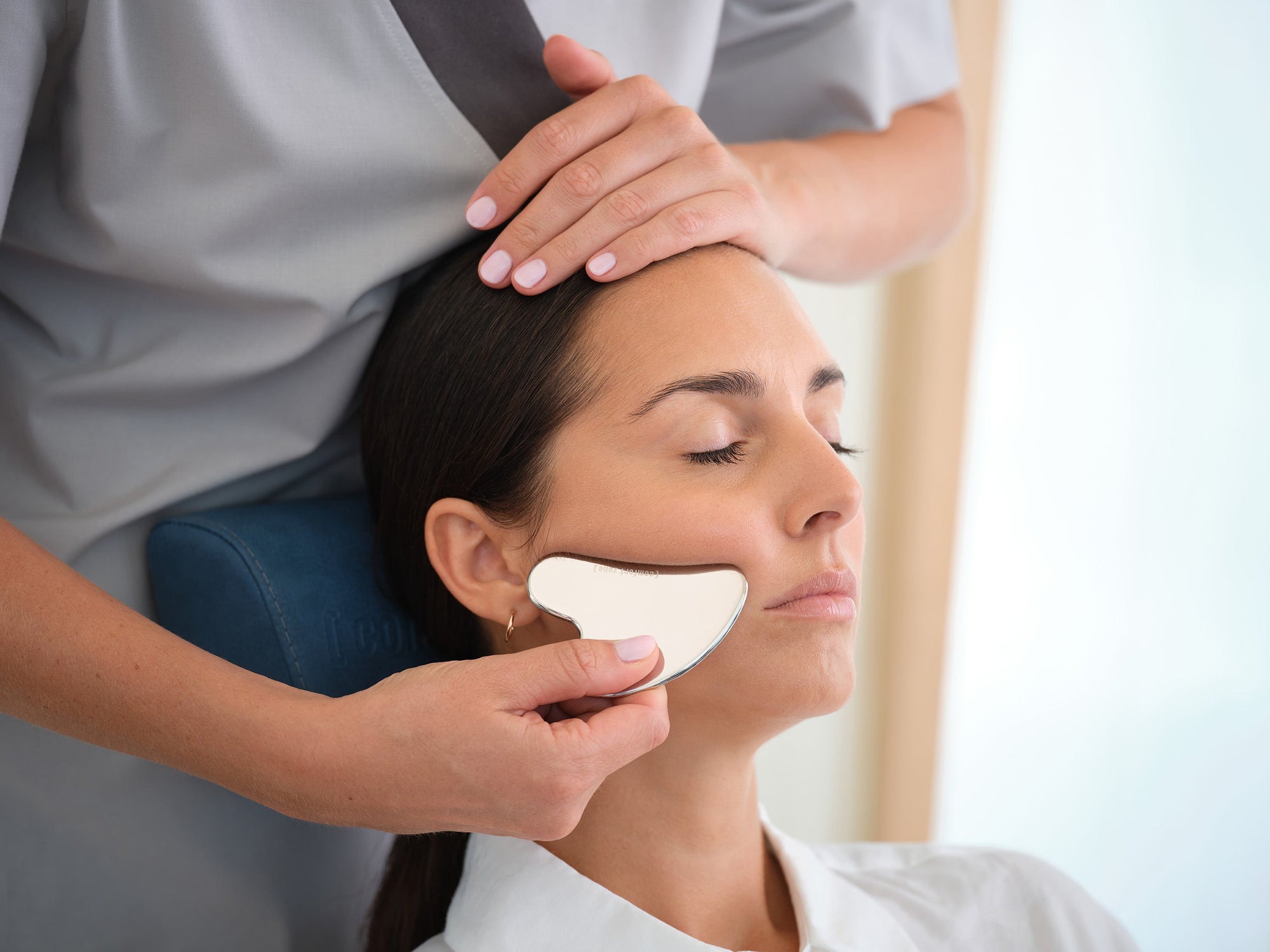Woman using Gua Sha