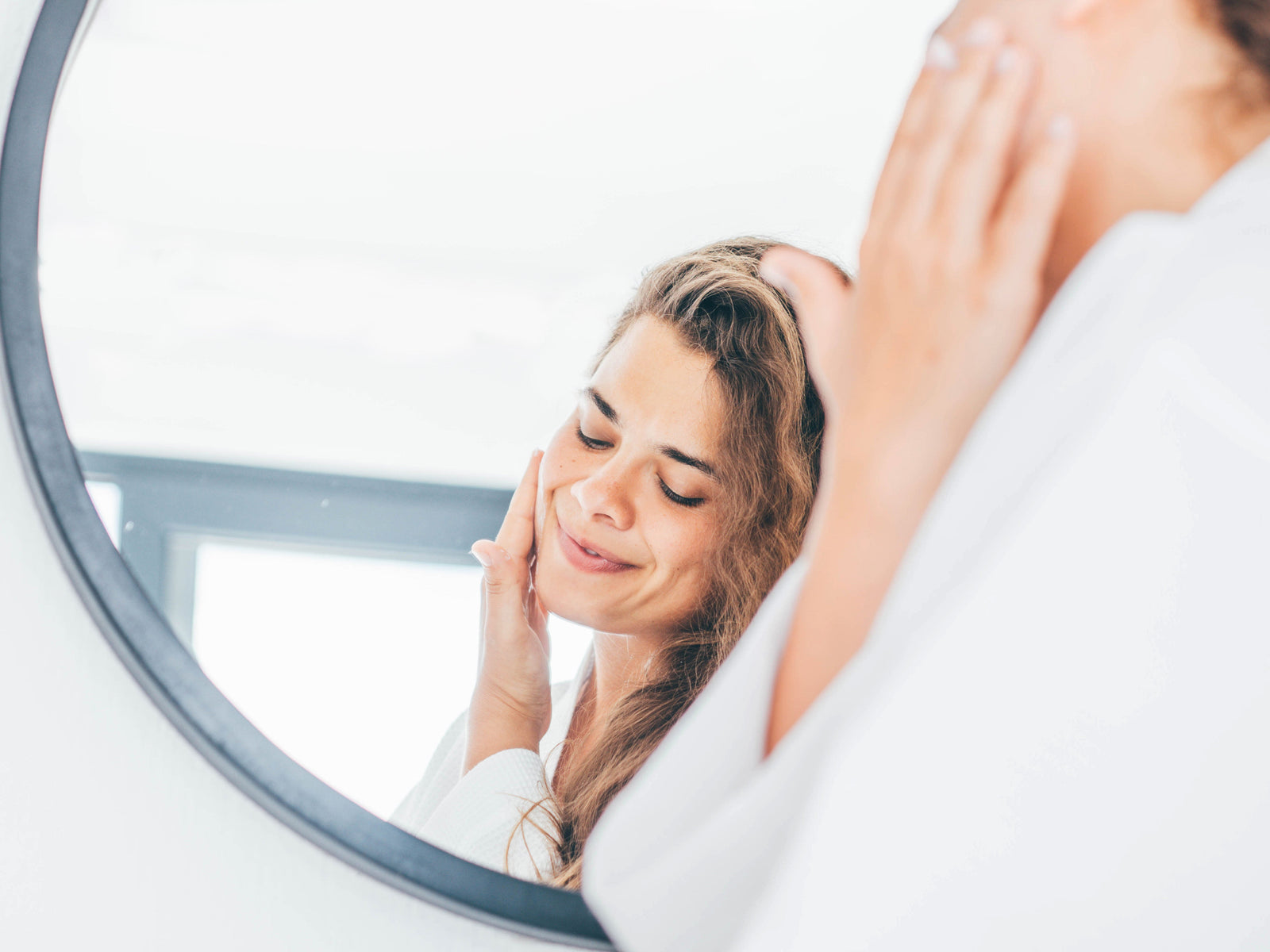 woman watching herself at the mirror