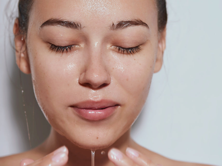 woman washing her face